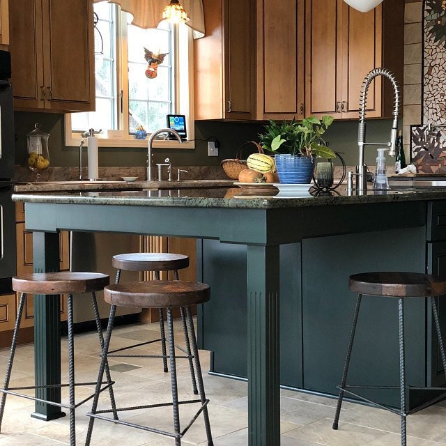 Bar stools in modern kitchen room with wooden furniture