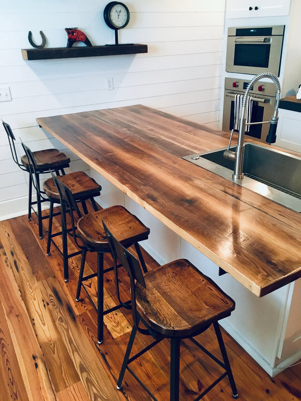 Bar stools with wooden top and back close to a kitchen table