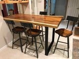 Bar stools with stylish wooden design close to a luxury wooden table in a small home kitchen